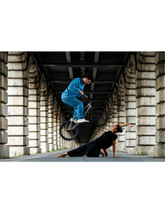 A BMX rider performing a jump over a dancer in an urban setting under a, captured with Nikon NIKKOR Z 24-70mm f/2.8 S II Lens A BMX rider performing a jump over a dancer in an urban setting under a, captured with Nikon NIKKOR Z 24-70mm f/2.8 S II Lens