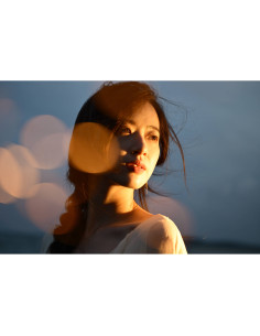 Woman with a soft expression, warm light, and bokeh background showing, captured with Nikon NIKKOR Z 24-70mm f/2.8 S II Lens Woman with a soft expression, warm light, and bokeh background showing, captured with Nikon NIKKOR Z 24-70mm f/2.8 S II Lens