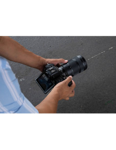 A person holding a camera, focused on capturing the scene, captured with Nikon NIKKOR Z 24-70mm f/2.8 S II Lens A person holding a camera, focused on capturing the scene, captured with Nikon NIKKOR Z 24-70mm f/2.8 S II Lens