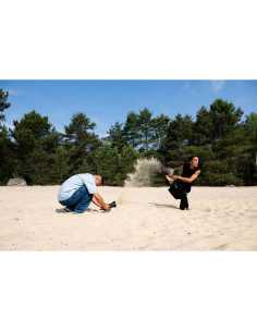 A photographer captures a model kicking up sand outdoors in a forested, captured with Nikon NIKKOR Z 24-70mm f/2.8 S II Lens A photographer captures a model kicking up sand outdoors in a forested, captured with Nikon NIKKOR Z 24-70mm f/2.8 S II Lens