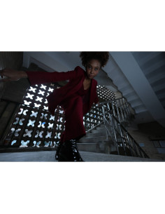 Model in burgundy outfit poses on staircase with dramatic low angle, captured with Sony FE 16mm f/1.8 G Model in burgundy outfit poses on staircase with dramatic low angle, captured with Sony FE 16mm f/1.8 G