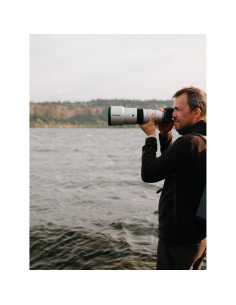 Man photographing a landscape by the water, captured with Fujifilm XF 500mm f/5.6 R LM OIS WR Man photographing a landscape by the water, captured with Fujifilm XF 500mm f/5.6 R LM OIS WR