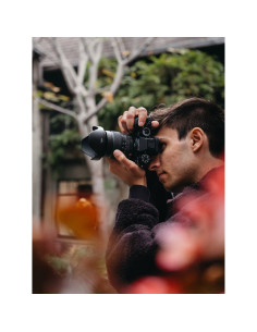 A young man photographing amidst colorful flowers in a garden setting, captured with Fujifilm XF 16-55mm f/2.8 R LM WR II A young man photographing amidst colorful flowers in a garden setting, captured with Fujifilm XF 16-55mm f/2.8 R LM WR II
