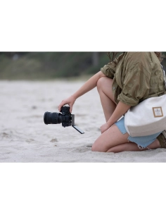A person kneeling on the beach holding a camera, wearing a casua, captured with Sony Alpha 7 V – Full Frame Mirrorless Camera A person kneeling on the beach holding a camera, wearing a casua, captured with Sony Alpha 7 V – Full Frame Mirrorless Camera
