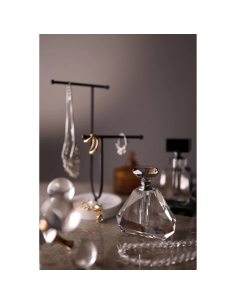 Elegant display of jewelry and perfume bottles on a textured surface, captured with Canon RF 35mm f/1.4 L VCM Elegant display of jewelry and perfume bottles on a textured surface, captured with Canon RF 35mm f/1.4 L VCM