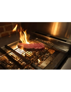 Steak grilling over an open flame with vibrant flames and warm lighting, captured with Canon RF 35mm f/1.4 L VCM Steak grilling over an open flame with vibrant flames and warm lighting, captured with Canon RF 35mm f/1.4 L VCM