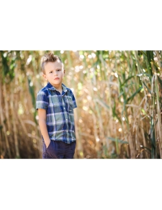 A young boy standing in a field of tall grass, looking contemplative under soft, captured with Canon RF 135mm f/1.8 L IS USM A young boy standing in a field of tall grass, looking contemplative under soft, captured with Canon RF 135mm f/1.8 L IS USM