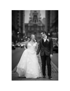 Couple walking hand in hand on a city street, dressed in wedding attire, urban b, captured with Canon RF 135mm f/1.8 L IS USM Couple walking hand in hand on a city street, dressed in wedding attire, urban b, captured with Canon RF 135mm f/1.8 L IS USM