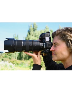A woman photographing a scenic outdoor landscape with a professional camera, captured with Nikon Z 70-200mm f/2.8 VR S II A woman photographing a scenic outdoor landscape with a professional camera, captured with Nikon Z 70-200mm f/2.8 VR S II