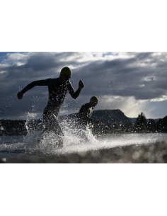 Two swimmers running through water against a dramatic sky, captured with Nikon Z 70-200mm f/2.8 VR S II Two swimmers running through water against a dramatic sky, captured with Nikon Z 70-200mm f/2.8 VR S II