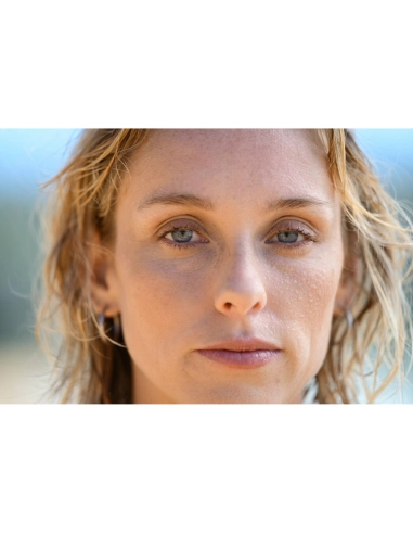 Outdoor portrait of a woman with wet hair and natural makeup, calm expression, captured with Nikon Z 70-200mm f/2.8 VR S II