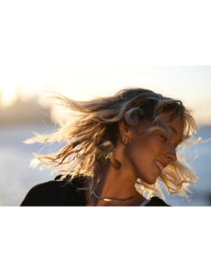 A woman with flowing hair in a beach setting during sunset, captured with Nikon Z 70-200mm f/2.8 VR S II A woman with flowing hair in a beach setting during sunset, captured with Nikon Z 70-200mm f/2.8 VR S II